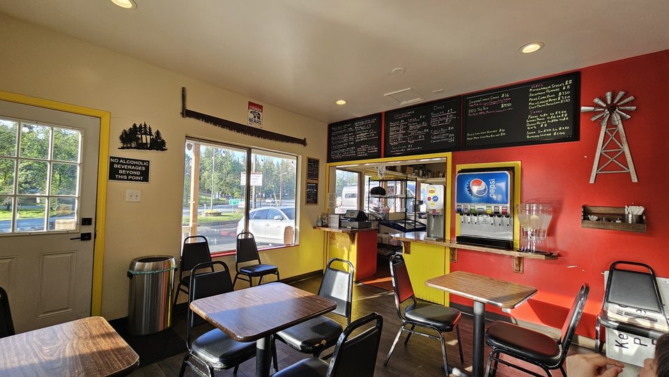 Casual burger restaurant interior with table seating.